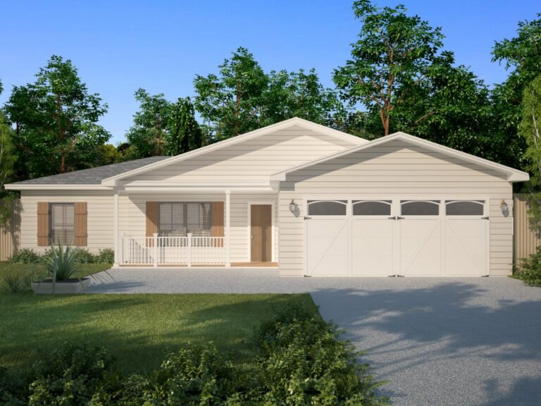 A front view of a simple, single-story home with a traditional design. The exterior features light beige siding, a gray shingled roof, and a two-car garage with white barn-style doors. The home includes a small covered front porch with white railings and wooden accents around the windows. The front yard is neatly maintained with a green lawn, shrubs, and a small garden area near the driveway. Tall trees surround the home, providing a natural backdrop under a clear blue sky.