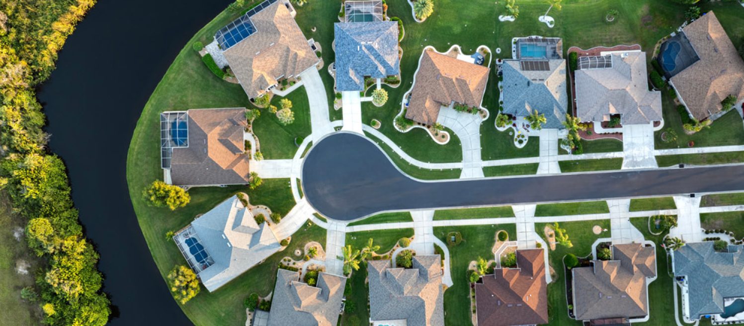 A picture of residential homes with pools in Gainesville, Florida near a retention pond.